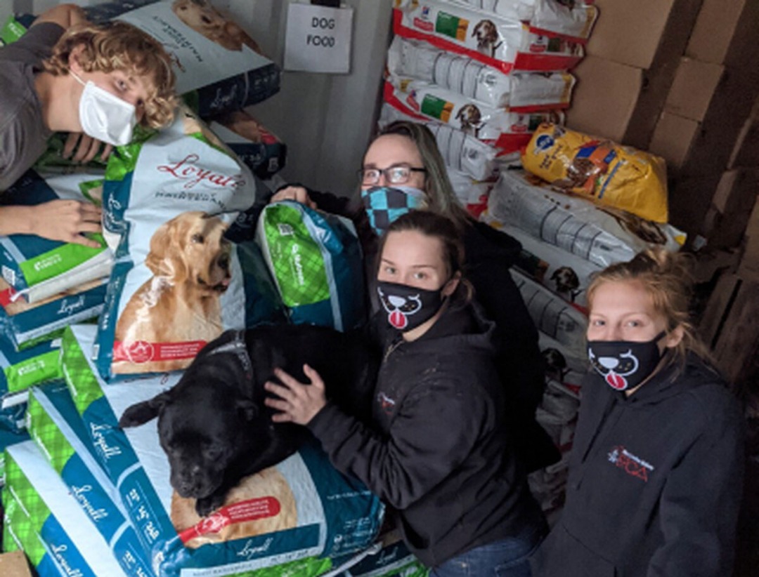 Family with their pet receiving food package